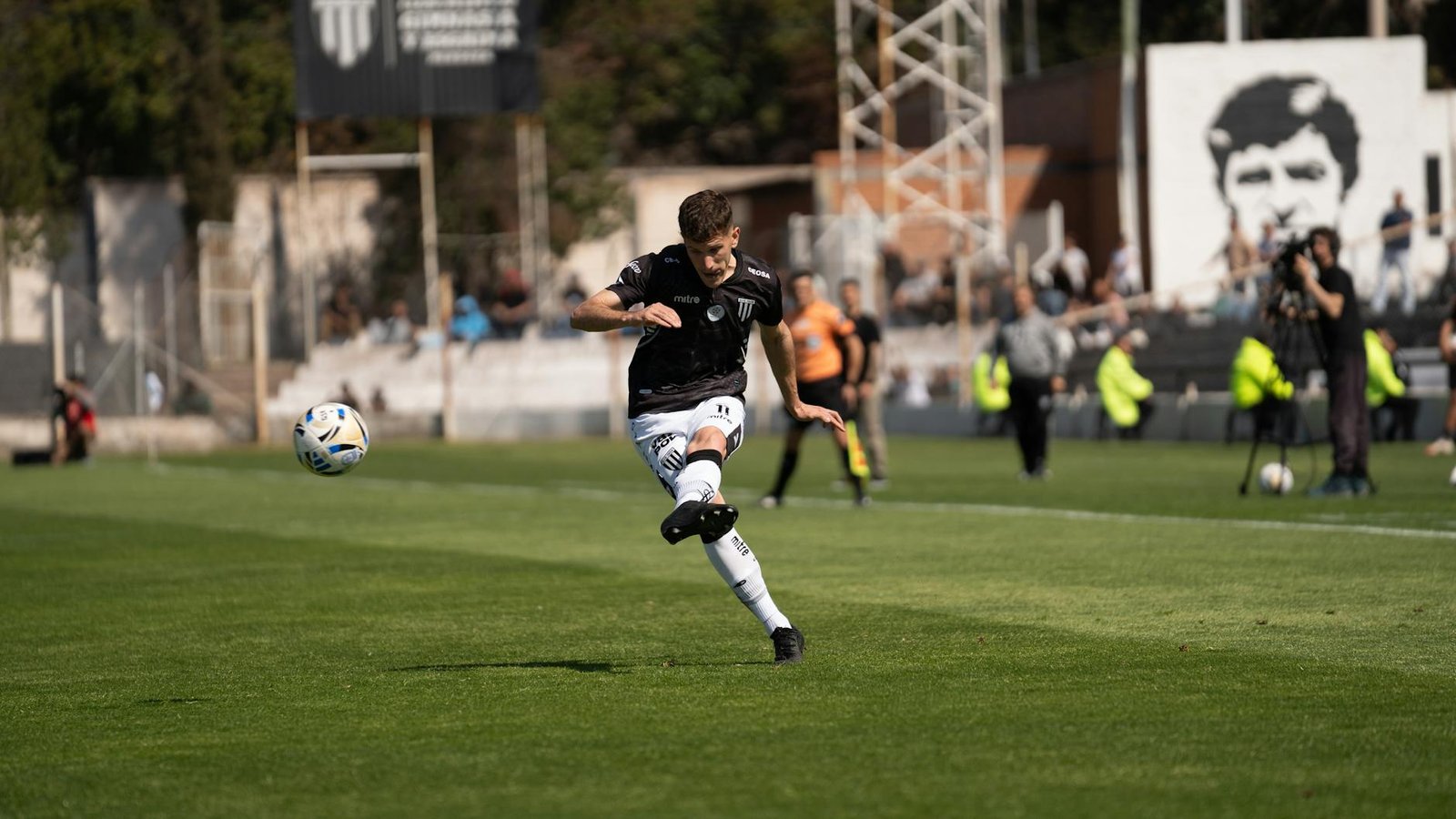 dynamic football player kicking ball on field